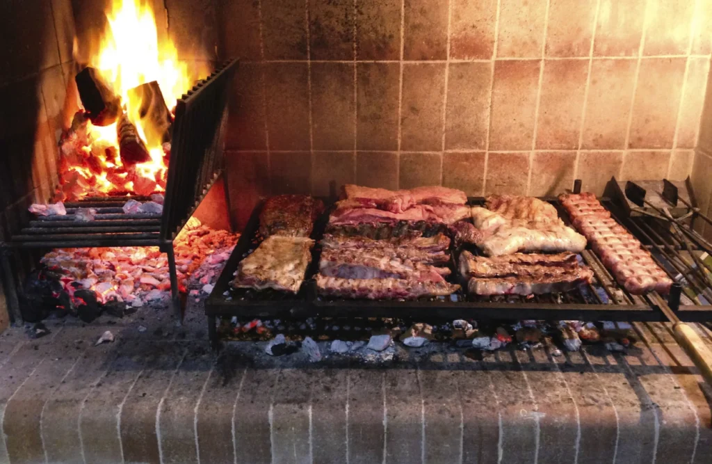 Traditional Argentinian asado grilling meats over an open flame in Patagonia.