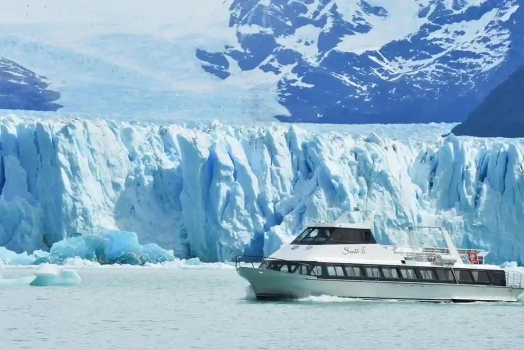Boat tour approaching the towering blue ice walls of Perito Moreno Glacier in El Calafate, Argentina.