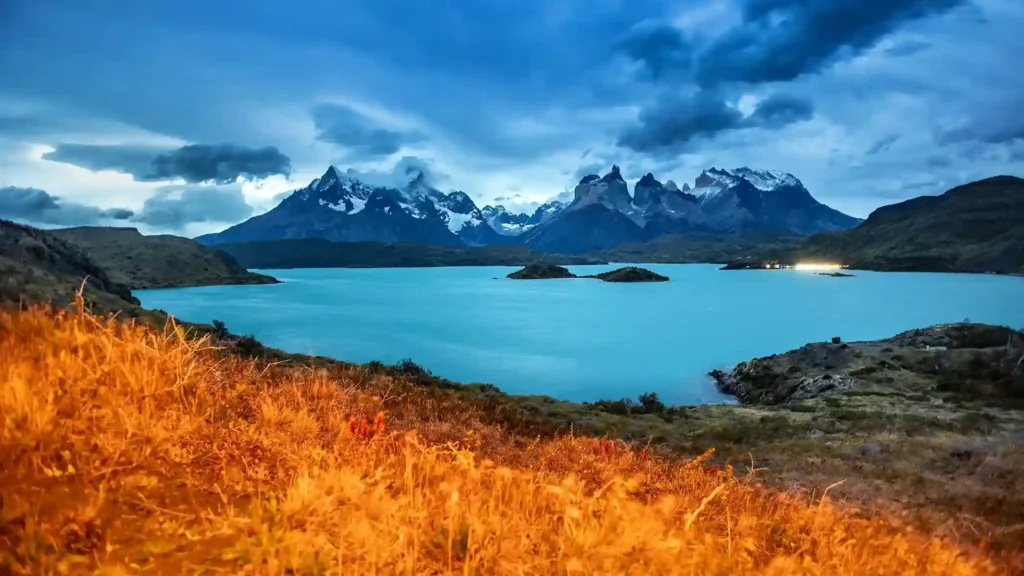 Dramatic mountain peaks and turquoise lake at Torres del Paine National Park in Chilean Patagonia.