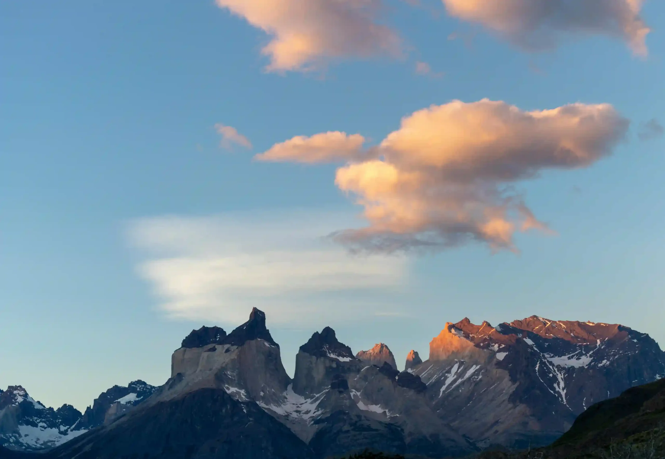 Sunset lighting up the distinctive peaks of the Torres del Paine massif, Patagonia, Chile.