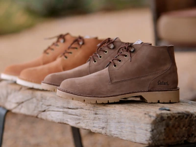 Safari boots displayed on a wooden bench, ideal footwear for Kenya bush conditions.