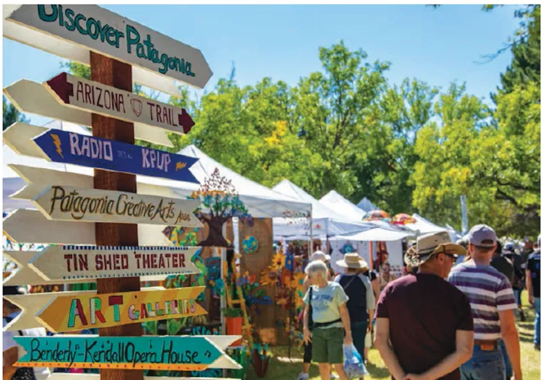 Outdoor autumn festival with local crafts, stalls, and visitors in a Patagonia-style setting.