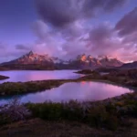 Panoramic sunrise view of the Torres del Paine mountain range and lakes in Patagonia.