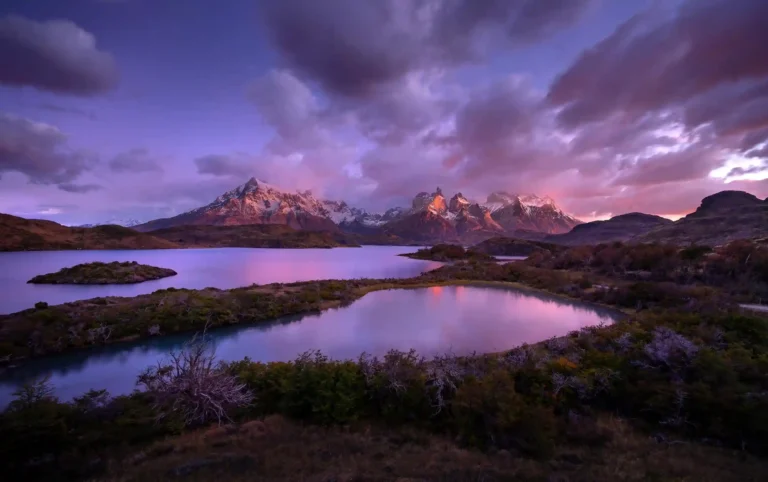 Panoramic sunrise view of the Torres del Paine mountain range and lakes in Patagonia.